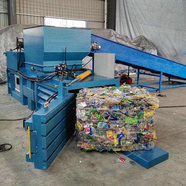 A_baler_machine_recycling_system_compresses_loose_cardboard_and_plastic_waste_into_dense_bales_for_easier_storage_and_transport..png
